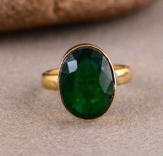 a green ring sitting on top of a rock