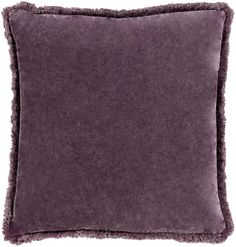 a dark purple pillow with fringe trim