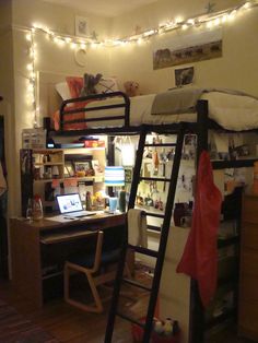 a bedroom with bunk beds and lights on the wall above it is lit up by string lights