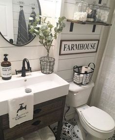 a white toilet sitting next to a sink in a bathroom under a mirror and a wooden cabinet