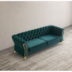 a green couch sitting on top of a rug