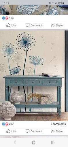 an image of a blue table with dandelions painted on the wall behind it