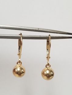 "Thanks for shopping our vintage estate store. We tend to sell well below wholesale and truly hope you enjoy all of our items. Many of the items are one of a kind, so please enjoy scrolling through the pictures and hopefully something will catch your eye. Brown spots are from camera or reflections. Nice estate 14k yellow gold ball dangle lever back earrings. Retails $199 on sale $99 Length: 3/4\" Size ball: 6mm 1/4\" Weight: .68 gram Studs are marked 14k and backs are included." Classic Yellow Gold Jewelry With Lever Back, Classic Lever Back Jewelry For Anniversary, Yellow Gold Round Jewelry With Lever Back, 14k Gold Round Lever Back Earrings, Gold Nugget Ring, Gold Nugget, Brown Spots, Earrings Studs, Earrings Etsy