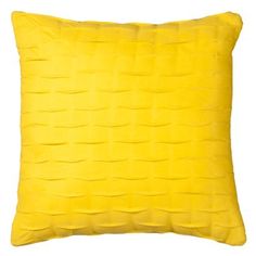 a yellow pillow on a white background