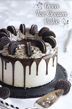 an oreo ice cream cake with chocolate cookies on top and drizzled in icing