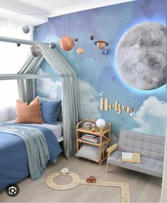 a child's bedroom decorated in blue and white with planets on the wall, curtains, and bedding