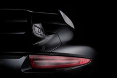 the tail light of a black sports car