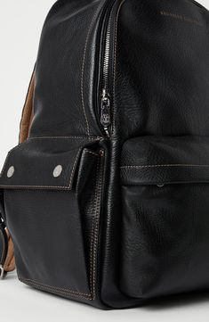 Manufacturing of the grained calfskin enriches the texture with slightly uneven coloring, giving the look of the leather a “vintage” flavor. On the inside, the accessory is lined in water-resistant fabric to protect its contents from the light contact with liquids. Zip closure Adjustable shoulder straps Handle Outside zipper pocket Side pockets with magnetic snaps Water-resistant fabric lining Internal compartment with zipper 3 open internal compartments Strap on back for attaching to trolley ha Luxury Leather Backpack With Textured Finish, Classic Textured Leather Backpack Bag, Luxury Textured Leather Backpack For Daily Use, Classic Leather Bag With Grained Texture, Black Leather Backpack With Leather Lining, Everyday Textured Leather Standard Backpack, Everyday Textured Leather Backpack, Luxury Leather Backpack With Smooth Grain, Luxury Leather Backpack With Textured Leather For Daily Use