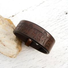 Hand painted and stamped Genuine leather cuff bracelet.Stamped buddhist mantra: Om Mani Padme HumLeather Width 23 mmAdjustable: wrist size 18 and 19,5 cmIf you need a diferent size, please let me know after purchase in "note for seller".Please visit to my another shop:https://www.etsy.com/shop/JeansBelt?ref=hdr_shop_menu**************************************************************************FEDEX to USA, Canada and Australia!If you need a faster shipping please use this service.The delivery ti Traditional Leather Bracelet, Adjustable Traditional Leather Bracelet, Traditional Brown Leather Bracelet As Gift, Adjustable Leather Spiritual Bracelet, Brown Leather Spiritual Bracelets, Spiritual Brown Leather Bracelets, Mens Leather Jewelry, Buddhist Mantra, Men's Leather Bracelet