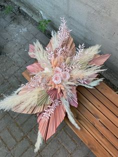 a bouquet of flowers sitting on top of a wooden bench