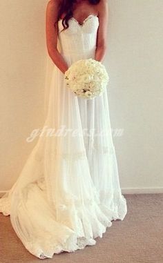 a woman in a wedding dress holding a bouquet