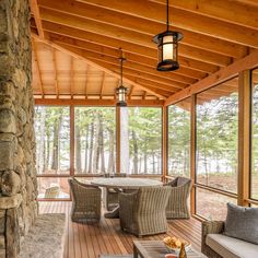 a covered porch with wicker furniture and wood flooring is featured in this image