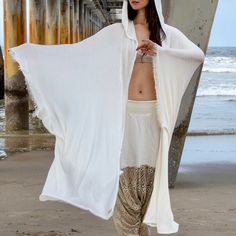 "White Knit Hooded Cloak. Great Festival or Ceremony Clothing. Amazing Long Soft Knit Kimono with the Hood! It is handmade from a high quality cotton/lycra knits fabric. The source of fabric was limited and only a few pieces are being made from it. Material: Up-cycled knits. Material was bought in Los Angeles, California, and the piece was hand-crafted in one of our studios in California. Size: One size Overall Length: 44-48 in. (Sides are longer). Fabric has a nice \"bouncy\" effect. Soft like Casual White Hooded Poncho, White One-size Beach Sweater, Hooded White Cotton Poncho, Hooded Kimono, Hooded Shawl, Knit Kimono, Silk Summer Dress, Harem Pants Men, Festival Clothes