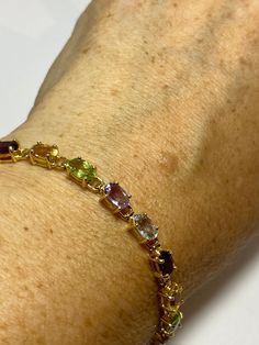 This genuine bright red garnet, citrine, blue topaz, amethysts, and peridot bracelet is very lively and bright. The stones are deep colors natural stones The sterling silver is plated with rhodium to protect the bracelet from tarnish 7.5 in Our jeweler can shorten it for $20 All jewelry is shipped free in the US in a nice gift box. Check out our over a THOUSAND great reviews Engraving is $4 per letter and is not always perfect depending on the piece. It can take a few days if the jeweler is busy Elegant Multicolor Birthstone Bracelets, Elegant Multicolor Birthstone Bracelet, Formal Multicolor Natural Gemstones, Elegant Multicolor Sterling Silver Bracelet With Stones, Elegant Multicolor Gemstone Sterling Silver Bracelet, Elegant Multicolor Stones Sterling Silver Bracelet, Multicolor Gemstone Sterling Silver Bracelet, Multicolor Birthstone Gemstones For Formal Occasions, Formal Multicolor Birthstone Gemstones