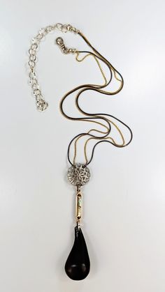 Silver Necklace - The Amika pendant ties it all together with a sterling silver wheel, an antique gold fill and abalone component, and a vintage African ebony drop. The signature double chain features a sterling silver snake chain mixed with a gold fill rounded box chain. The necklace is 19 inches long with a 4 inch extender chain. Silver Brass Snake Chain Necklaces, Silver Brass Snake Chain Necklace, Silver Snake Chain Necklace In Brass, Silver Brass Necklace With Snake Chain, Luxury Silver Brass Necklace, Silver Brass Necklace With Box Chain, Silver Brass Box Chain Necklace, Elegant Oxidized Snake Chain Jewelry, Artful Home