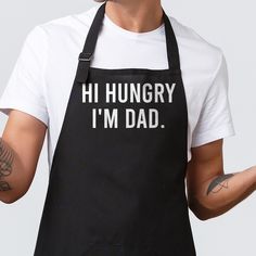 a man wearing an apron with the words hi hungry i'm dad on it