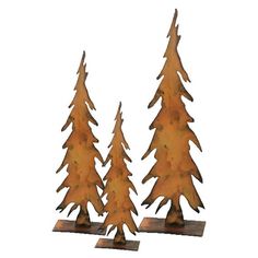 two metal pine trees are standing next to each other