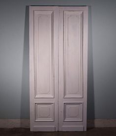 an empty room with two white doors in it