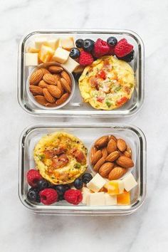 two plastic containers filled with food on top of a marble countertop next to each other