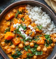 a bowl filled with rice, chickpeas and spinach next to pita bread