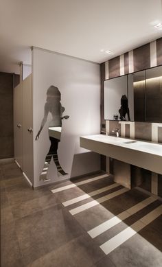 a bathroom with two sinks and a large mirror on the wall next to each other