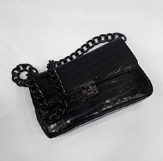 An elegant classic style bag with a strong scent of the legendary original designs that marked deeply the modern fashion, made of high quality genuine greek calf leather, processed properly in order to resemble croc leather. The bag's inner space is seperated in three (3) divisions, as also a zipped pocket is included. The chain is made of black nickel and it's proper for the use of the bag as a Shoulder Bag. The bag includes a safety lock, which can be opened simply via sliding the small round Luxury Baguette Bag With Chain Strap, Luxury Rectangular Baguette Bag With Chain Strap, Luxury Square Clutch For Office, Luxury Soft Leather Rectangular Shoulder Bag, Elegant Leather Satchel Baguette Bag, Elegant Textured Leather Baguette Bag For Everyday Use, Elegant Leather Baguette Bag With Detachable Strap, Luxury Soft Leather Baguette Bag For Business, Luxury Soft Leather Business Baguette Bag