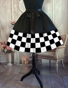 PRE-ORDER Fabric due early to mid February Checkered Flag fifties style skirt suitable for plus sizes.  Going to a Vintage Car Rally or auto event? then you'll love this full, rockabilly style checkerboard skirt. Plus sizing is absolutely no problem with a fully adjustable ribbon tie waist expanding up to 55 inches.  The skirt measures approximately 57 cms (22 inches) in length and looks best with the tulle petticoat underneath to puff it out.  FULL SKIRT SIZING: One Size - Adjustable sizing using the satin ribbon waist drawstring.  Waist expands to 55 inches. PETTICOAT SIZING:  One size only with a drawstring adjustable waist. Fits max waist measurement up to 110 cms (43 inches) and hips up to 130cms (51 inches) Checkered Skirt, Party Rock, Fifties Fashion, Hip Ups, Checkered Flag, Party Skirt, Rockabilly Fashion, 1920s Fashion, Petticoat