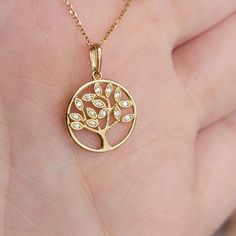 These shimmery symbolic tree Necklace feature 0.07Ctw of genuine diamonds, A valuable piece for yourself or a special gift for your loved ones! The Tree of Life symbol represents our personal development, uniqueness, and individual beauty. Just as the branches of a tree strengthen and grow upwards to the sky, we too grow stronger, striving for greater knowledge, wisdom, and new experiences as we move through life. ♥Details Height: 12mm Width: 12mm Thickness: 1.mm Stone material: genuine diamond Elegant Tree Of Life Jewelry For Anniversary, Elegant White Gold Tree Of Life Jewelry, Elegant Tree Of Life Necklace For Anniversary, Tree Of Life Symbol, Real Gold Necklace, Solid Gold Charms, Necklace Tree, Life Symbol, Stone Material