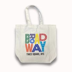 Made of quality cotton material, our durable canvas BROADWAY, TIMES SQUARE, NYC tote bag will put your love of all things Broadway front and center! It features a screen printed design on white cotton. Trendy White Square Canvas Bag, White Logo Print Shopping Bag, Rectangular Canvas Bag For Travel With Logo Print, Everyday Rectangular Bags With Logo Print, Rectangular Logo Print Canvas Travel Bag, Rectangular Canvas Bag With Graphic Print For Everyday Use, Trendy Rectangular Canvas Bag With Graphic Print, Everyday Canvas Bags With Logo Print, Trendy Square Cotton Canvas Bag