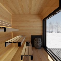 a room with wooden walls and benches in the snow next to an open window that looks out onto a snowy landscape