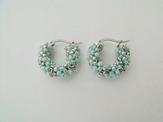 "This pair of beaded hoop earrings were woven with tiny sea foam green and silver glass beads.  The beads were weaved onto tarnish resistant stainless steel latch style hoops. Finished hoops measure:  .75\" of an inch across the widest part of the earrings ( i.905 cm ) outside diameter. https://www.etsy.com/shop/FMGuyDesigns" Silver Beaded Earrings With Tiny Round Beads, Handmade Silver Small Hoop Beaded Earrings, Small Silver Hoop Earrings With Tiny Beads, Silver Small Hoop Earrings With Tiny Beads, Handmade Silver Beaded Small Hoop Earrings, Silver Beaded Round Hoop Earrings, Silver Hoop Earrings With Tiny Beads, Bohemian Green Small Hoop Beaded Earrings, Summer Beaded Green Hoop Earrings