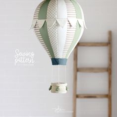 an origami hot air balloon hanging from a ladder