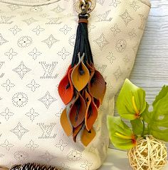 a white purse sitting on top of a table next to a plant