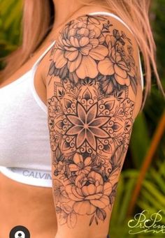 a woman's arm with flowers on it