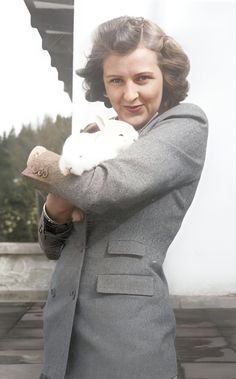 a woman holding a stuffed animal in her hands