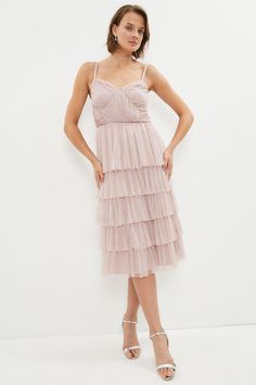 Showing off romantic ruffles and tasteful tiers, this beautiful midi dress needs no introduction. Its structured bodice and slender spaghetti straps contrast ethereally with a skirt that swishes elegantly as you move.Style: Full Skirted DressFabric: TulleLength: MidiNeckline: V NeckSleeve Length: Strappy Latest Bridesmaid Dresses, Beautiful Midi Dresses, Bridesmaid Dress Collection, Ruffle Midi Dress, Pink Midi Dress, Long Bridesmaid Dresses, Wedding Bridesmaids, Full Skirt, Dress Collection