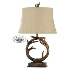 a lamp that is sitting on top of a wooden base with a light shade over it