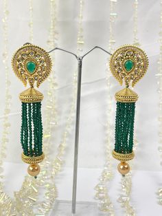 The epitome of traditional elegance and timeless beauty. These stunning earrings are crafted to be a standalone statement piece, designed to captivate and elevate your style to new heights. Whether you're attending a grand wedding, a lively party, or any special event, our Meena/Kundan Earrings will effortlessly complement your attire and make you the center of attention. Our Meena/Kundan Earrings are your go-to choice for all your special occasions. From weddings to parties, from cultural events to festivals, these earrings will elevate your style and make you shine wherever you go. They are the perfect accessory to make a lasting impression. Elegant Green Danglers For Celebration, Elegant Plug Earrings For Festive Celebration, Elegant Festive Celebration Plug Earrings, Elegant Chandbali Beaded Earrings For Festivals, Elegant Green Chandbalis With Latkans, Elegant Drop Beaded Earrings For Festivals, Elegant Festive Beaded Earrings, Elegant Green Danglers For Festivals, Elegant Green Dangle Chandbalis