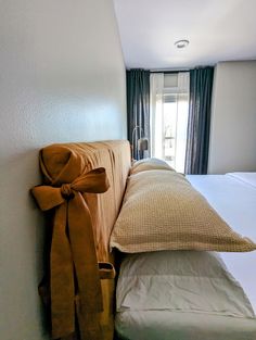 a bed with a bow on the headboard