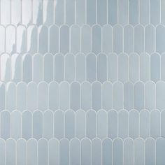 a white tiled wall with rounded shapes