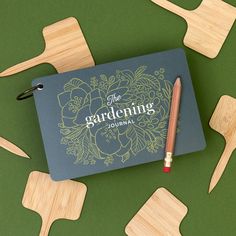 the gardening journal surrounded by wooden utensils