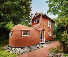 an unusual house in the middle of some trees