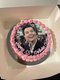 a birthday cake in a box with an image of the actor and his name on it