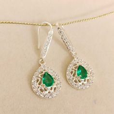 Gemstone :- Lab Created Emerald Stone Color:- Green Stone Shape:- Pear Stone size : 7x5 mm Metal :- Sterling Silver Side stone :- American Diamond / CZ Setting :- Bezel Setting Style :- Classic Length :- 3.5 cm Width :- 1.5 cm Closure :- Ear Wire Plating :- White Gold => Payment Policy We accept payment through PayPal. All payments must be made within 4 days of purchase. => Shipping Policy All Item will Be Shipped Through UPS, India Post International, DHL eCommerce or within 3-5 Business Sterling Silver Pear-shaped Earrings With Sparkling Stones, Sterling Silver Teardrop Earrings With Sparkling Stones For Gift, Pear-shaped Sterling Silver Earrings With Sparkling Stones, Gift Sterling Silver Teardrop Earrings With Sparkling Stones, Cubic Zirconia Teardrop Earrings For May Birthstone, Sparkling Stone Pear Earrings As Gift, Teardrop Gemstone Bridal Earrings In Sterling Silver, Teardrop Sterling Silver Gemstone Bridal Earrings, Pear-shaped Earrings With Sparkling Stones For Gift