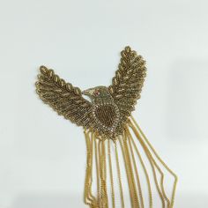 Stunning Embroidered Eagle Patch with Suspended Golden Chains, a regal and captivating accessory that will elevate your projects to new heights of grandeur. Meticulously crafted with intricate embroidery, this applique patch features a majestic eagle design enhanced with suspended golden chains, creating a truly mesmerizing and opulent piece. ➤➤Dimensions : Size - 13 x 11 cm. ➤➤ Delivery time : 8-10 business days anywhere in the world with standard shipping ➤➤ There may be some difference in color due to lighting and screen settings. Embroidered Festive Jewelry For Parties, Elegant Embroidered Festive Jewelry, Elegant Embroidered Jewelry For Festive Occasions, Traditional Embellished Gold Necklace, Traditional Gold Embellished Necklace, Traditional Embellished Formal Jewelry, Gold Embellished Jewelry For Formal Occasions, Formal Embellished Gold Jewelry, Formal Gold Embellished Jewelry