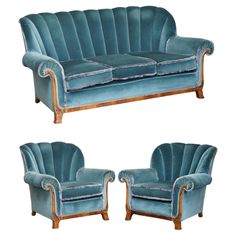 two blue velvet couches with wooden legs