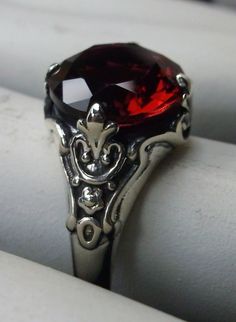 Simulated Red Ruby ring Paws Design#115 Custom made This is a Victorian reproduction ring in sterling silver with a lovely red gemstone. This high quality flawless Man-made red ruby has great shine and a lovely captivating color. The full cut approx. 3ct gemstone is 10mm (3/8th of an inch) in diameter. The inside of the band is marked 925 for sterling. Notice the beautiful floral antique design of the silver filigree setting and band. A gift ring box is included and all rings are shipped in the Classic Red Jewelry With Lab-created Ruby, Classic Red Lab-created Ruby Jewelry, Classic Red Jewelry With Round Cut, Classic Red Round Cut Jewelry, Classic Red Ruby Jewelry, Classic Red Birthstone Jewelry, Classic Red Birthstone Ring, Red Lab-created Ruby Jewelry, Classic Ruby Crystal Ring