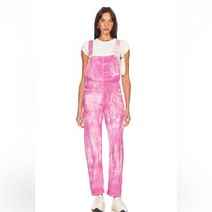 Free People's Done It Again With The Ziggy Denim Overall In Electric Bouquet. These Washed Tie-Dye Denim Overalls Feature 8-Pocket Styling And Rigid Denim Fabric With Button Sides. A Playful Twist On Classic Overalls, They Add A Pop Of Style To Your Wardrobe, Combining Comfort With A Vibrant, Eclectic Look. 100% Cotton Made In Morocco Machine Wash Pull-On Styling With Adjustable Shoulder Straps 8-Pocket Styling Rigid Denim Fabric With Button Sides Revolve Style No. Free-Wc331 Manufacturer Style Relaxed Fit High Rise Denim Jumpsuit, Spring Overall Relaxed Fit Pants, Spring Relaxed Fit Overalls, Acid Wash Cotton Pants For Spring, Spring Acid Wash Cotton Pants, Pink Relaxed Fit Cotton Overalls, Mid-rise Cotton Denim Jumpsuit With Relaxed Fit, Mid-rise Cotton Denim Jumpsuit In Relaxed Fit, Relaxed Fit Mid-rise Cotton Denim Jumpsuit