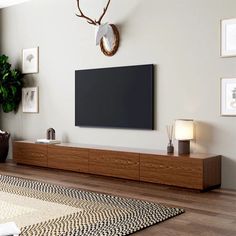 a living room with a large flat screen tv mounted on the side of it's wall