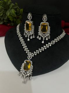 Gorgeous fine quality imitation jewellery  CZ Yellow with diamonds studded necklace with white gold rhodium plating and matching Earrings Item contains: Necklace and earrings AAA quality cubic zirconia used. Highest quality and craftsmanship Necklace Fitting is adjustable Earrings Closure: Pushback Necklace Closure: chain with Hook Details-  -Handmade item -Delivery from a small business in India -Materials: white rhodium, stones, cz, zircon, American diamond -Jewellery type: Earrings, Necklace Necklace Closure, Bollywood Party, American Diamond Jewellery, Vintage India, Studded Necklace, Color Necklace, Cz Jewelry, Wedding Jewellery Necklace, American Diamond